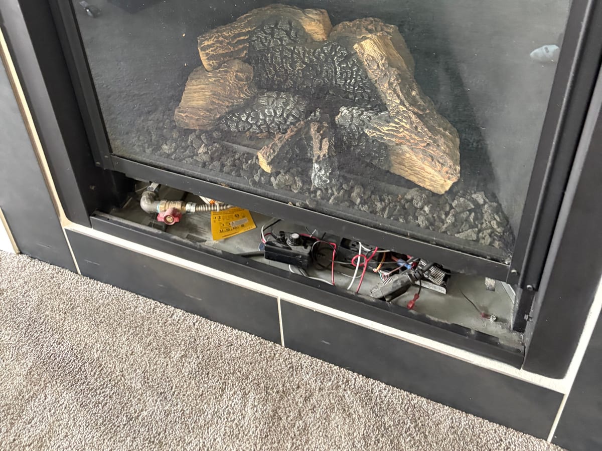 A gas fireplace burner opened up for service by XFire Solution